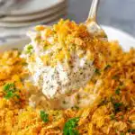 Poppy seed chicken casserole baked in a white 9x13 dish with golden buttery cracker topping fresh from the oven