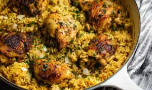 Creamy ranch chicken and rice recipe in a large saute pan topped with fresh parsley