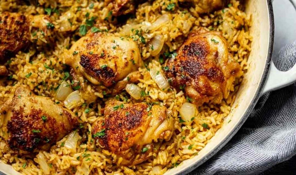 Creamy ranch chicken and rice recipe in a large saute pan topped with fresh parsley