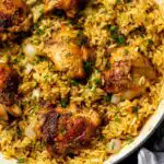 Creamy ranch chicken and rice recipe in a large saute pan topped with fresh parsley
