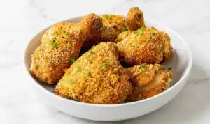 Homemade Shake and Bake Chicken on a wire rack with a golden crispy Panko coating