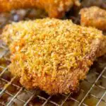 Homemade Shake and Bake Chicken on a wire rack with a golden crispy Panko coating