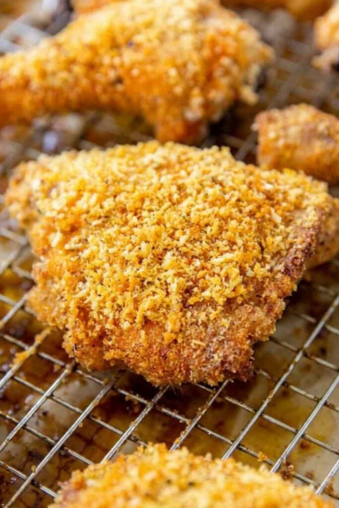 Homemade Shake and Bake Chicken on a wire rack with a golden crispy Panko coating