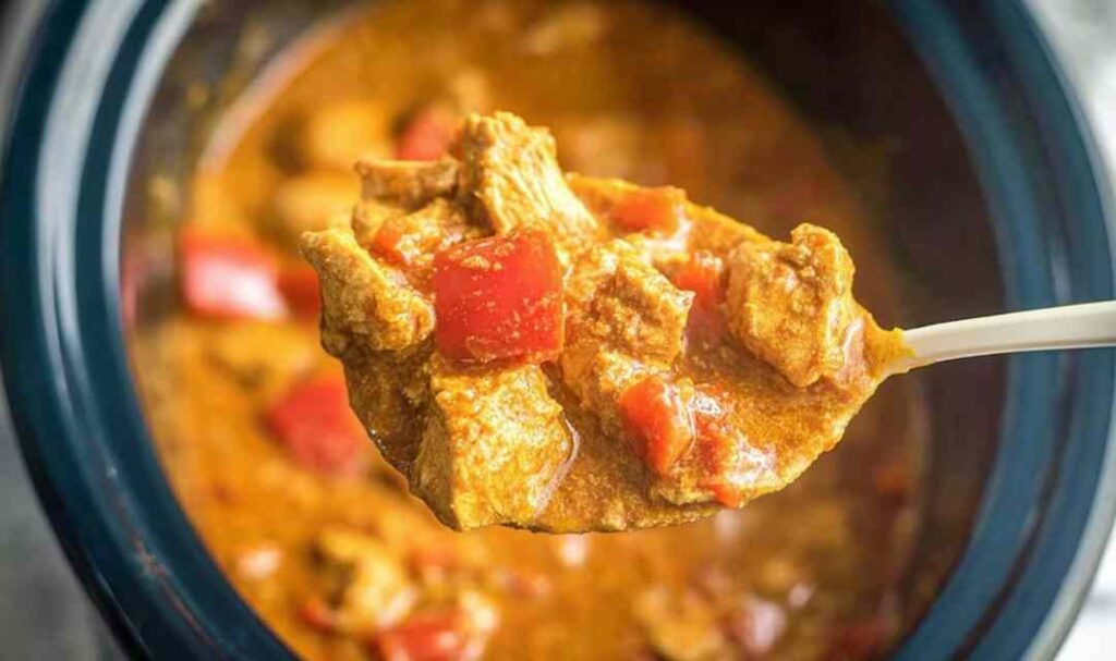 Slow cooker peanut chicken served over jasmine rice with scallions and fresh lime
