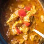 Slow cooker peanut chicken served over jasmine rice with scallions and fresh lime