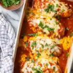 Southwest chicken bake in a white baking dish topped with melted Mexican cheese and fresh cilantro